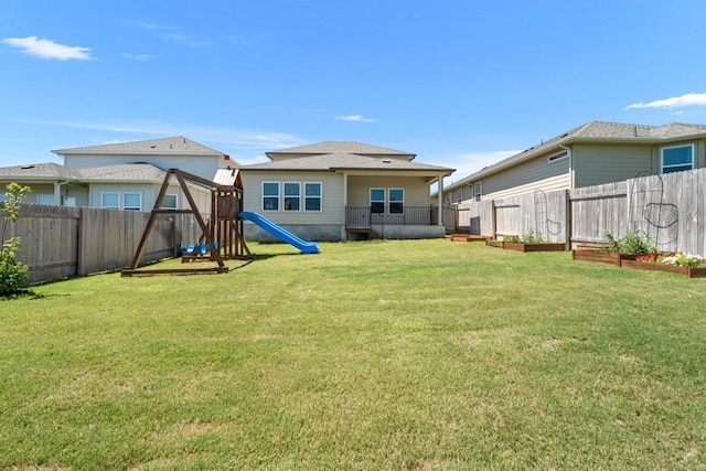 207 El Capitan Loop, Dripping Springs, TX 78620 - back of property with a playground, a fenced backyard, and a garden