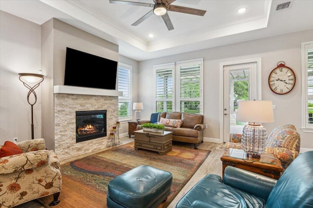 202 Iron Rail Ln, Georgetown, TX 78633 - living area with wood finished floors, a ceiling fan, plenty of natural light, a tray ceiling, and crown molding