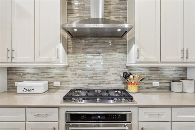 202 Iron Rail Ln, Georgetown, TX 78633 - kitchen featuring wall chimney range hood, appliances with stainless steel finishes, light countertops, and white cabinets