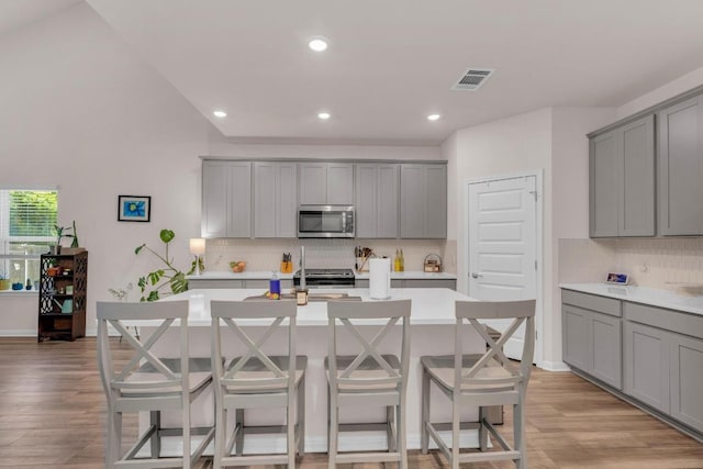 133 Fairmeadow Downs Dr, Hutto, TX 78634 - kitchen featuring gray cabinetry, stainless steel microwave, and recessed lighting