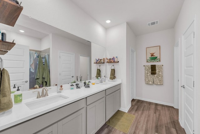 133 Fairmeadow Downs Dr, Hutto, TX 78634 - full bath featuring double vanity, wood finished floors, a shower, and recessed lighting