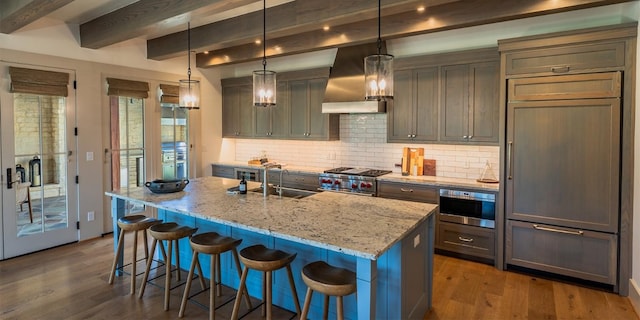 174 Putting Park Dr, Fredericksburg, TX 78624 - kitchen featuring stainless steel stove, range hood, wood finished floors, paneled built in refrigerator, and beamed ceiling