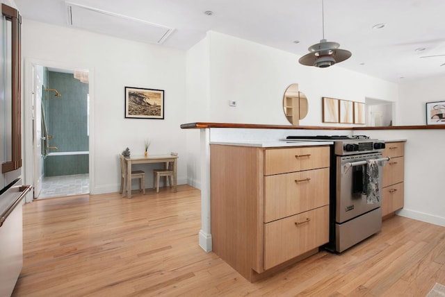 1608 Hether St, Austin, TX 78704 - kitchen featuring gas stove, light brown cabinetry, light wood-type flooring, modern cabinets, and light countertops