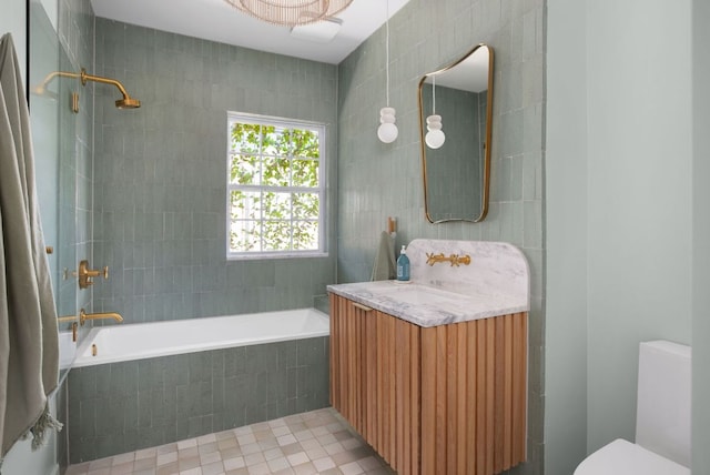 1608 Hether St, Austin, TX 78704 - bathroom featuring vanity, tile walls, and tiled shower / bath combo