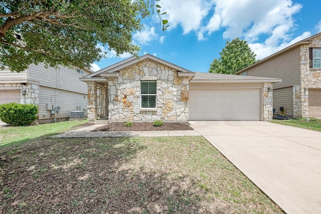 486 Nottingham Loop, Kyle, TX 78640 - view of front of house featuring stone siding, an attached garage, and concrete driveway
