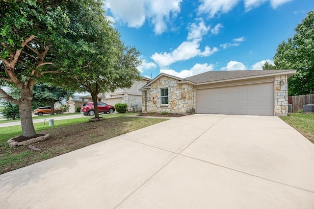 486 Nottingham Loop, Kyle, TX 78640 - view of front of property featuring stone siding, a garage, and driveway