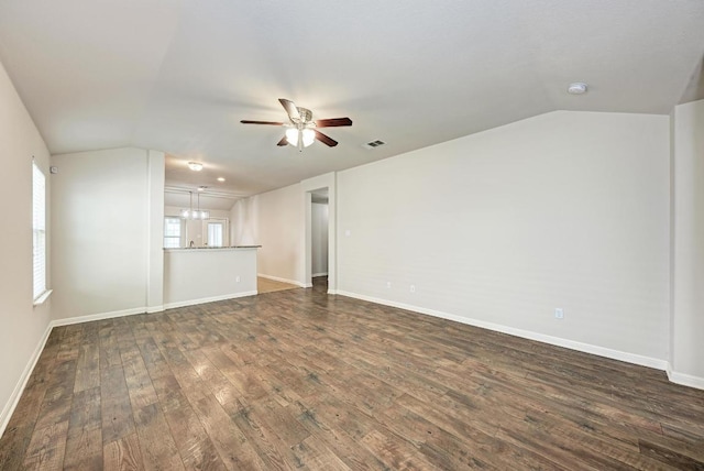 486 Nottingham Loop, Kyle, TX 78640 - unfurnished living room featuring vaulted ceiling, a ceiling fan, and dark wood-style flooring