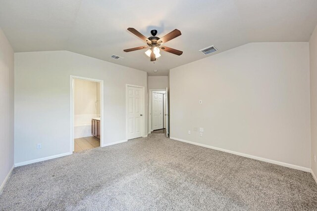 486 Nottingham Loop, Kyle, TX 78640 - unfurnished bedroom with lofted ceiling, light colored carpet, ensuite bath, and a ceiling fan