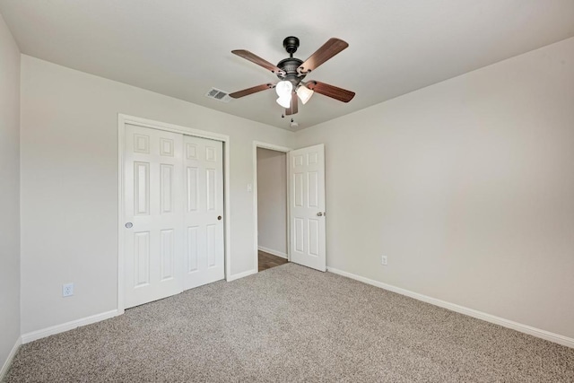 486 Nottingham Loop, Kyle, TX 78640 - unfurnished bedroom featuring carpet, a closet, and a ceiling fan
