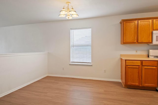 2733 Crimson Sky Ct, Round Rock, TX 78665 - unfurnished dining area featuring a chandelier and light wood-style flooring