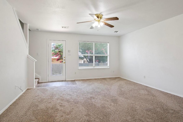 2733 Crimson Sky Ct, Round Rock, TX 78665 - carpeted spare room featuring ceiling fan and stairway