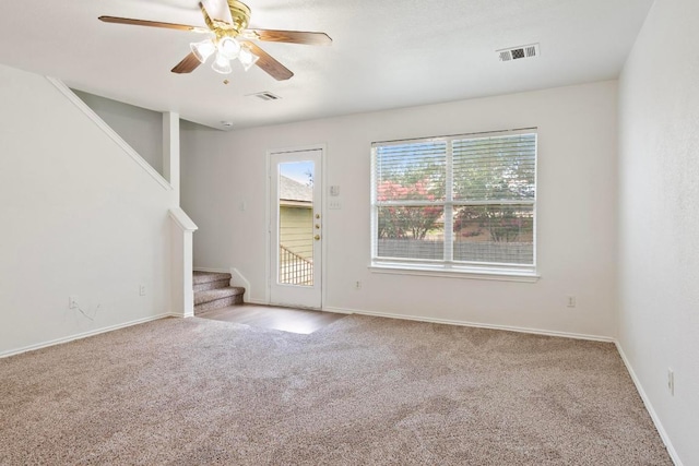 2733 Crimson Sky Ct, Round Rock, TX 78665 - unfurnished living room with carpet floors, stairway, and a ceiling fan