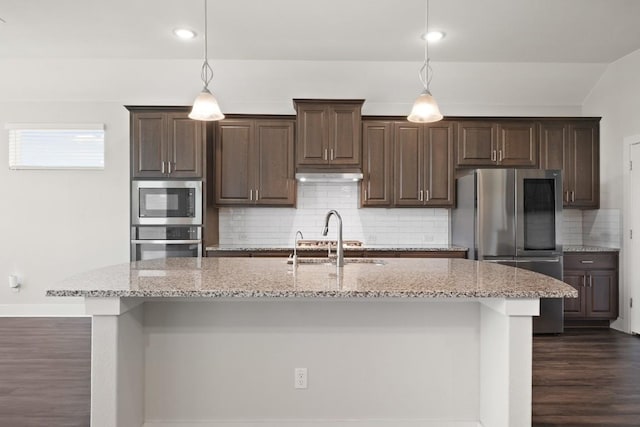 18017 Prato Dr, Pflugerville, TX 78660 - kitchen with appliances with stainless steel finishes, dark brown cabinetry, under cabinet range hood, and recessed lighting