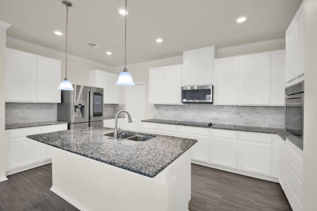 12505 Franklin D Roosevelt St, Manor, TX 78653 - kitchen featuring appliances with stainless steel finishes, crown molding, decorative backsplash, dark stone counters, and dark wood-style floors