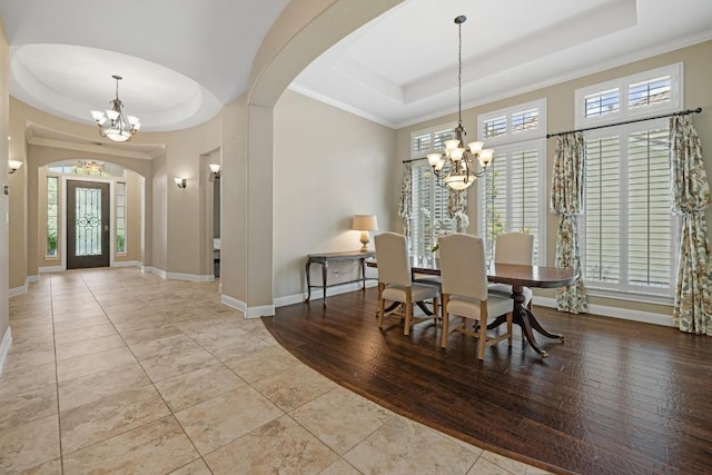 11516 Shoreview Overlook, Austin, TX 78732 - tiled dining room featuring a raised ceiling, a chandelier, and arched walkways