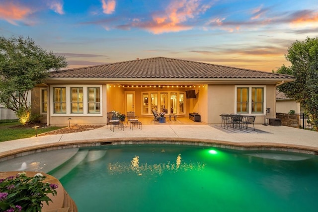 11516 Shoreview Overlook, Austin, TX 78732 - rear view of property featuring a tiled roof, a patio area, and an outdoor pool