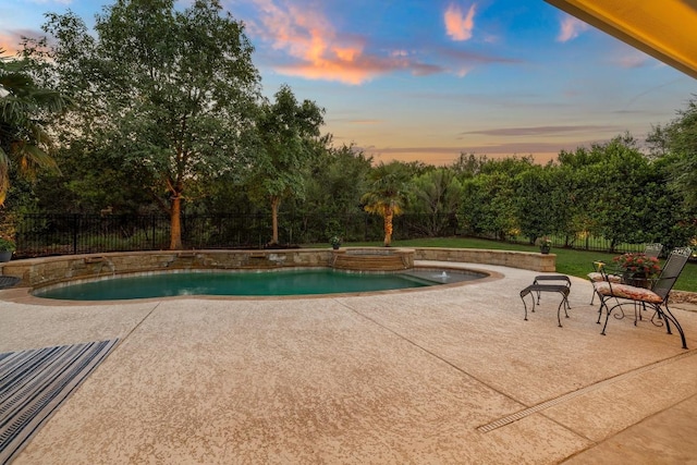 11516 Shoreview Overlook, Austin, TX 78732 - pool at dusk with a patio, a fenced backyard, and a pool with connected hot tub