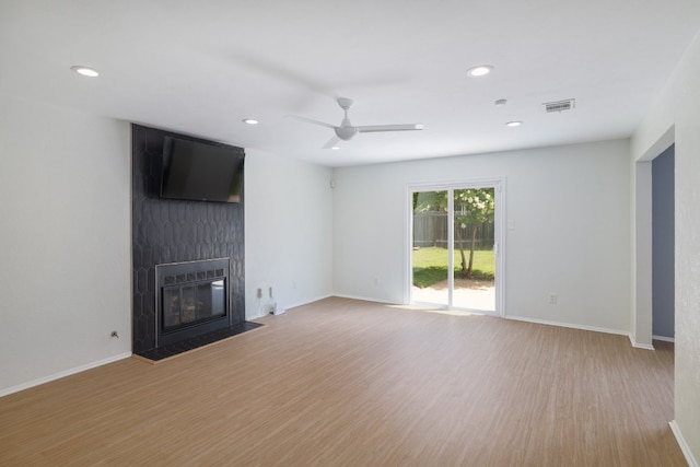 2616 Aylesbury Ln, Austin, TX 78745 - unfurnished living room with ceiling fan, wood finished floors, recessed lighting, and a large fireplace