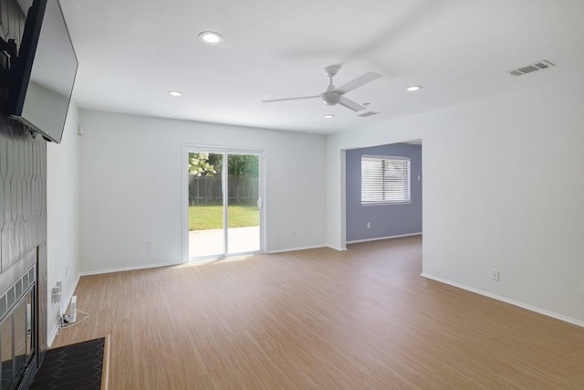 2616 Aylesbury Ln, Austin, TX 78745 - unfurnished living room featuring a ceiling fan, wood finished floors, recessed lighting, and a fireplace