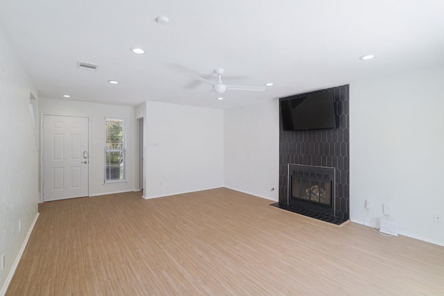 2616 Aylesbury Ln, Austin, TX 78745 - unfurnished living room featuring ceiling fan, wood finished floors, a large fireplace, and recessed lighting