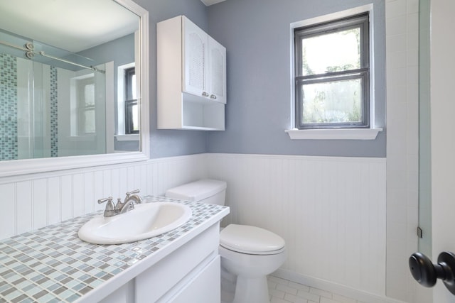 2616 Aylesbury Ln, Austin, TX 78745 - bathroom featuring wainscoting, vanity, a shower, and tile patterned floors
