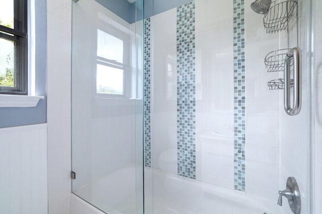 2616 Aylesbury Ln, Austin, TX 78745 - bathroom with bath / shower combo with glass door and a wainscoted wall