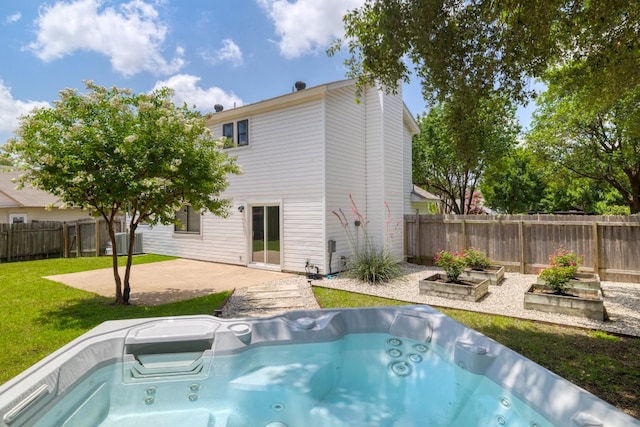 2616 Aylesbury Ln, Austin, TX 78745 - rear view of house featuring a hot tub, a patio area, and a fenced backyard