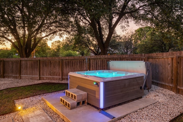 2616 Aylesbury Ln, Austin, TX 78745 - patio terrace at dusk featuring a hot tub and a fenced backyard