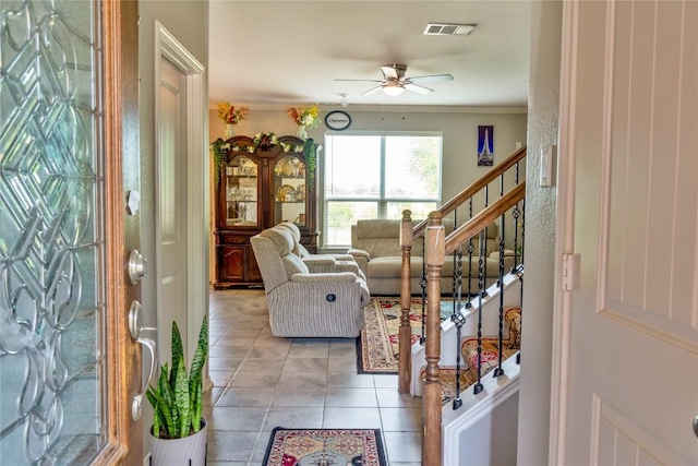 2471 Sunrise Rd Unit 35, Round Rock, TX 78664 - foyer entrance with a ceiling fan, stairway, light tile patterned flooring, and crown molding