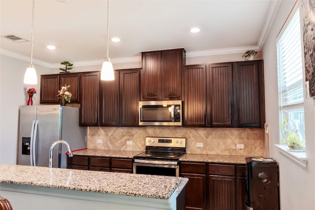 2471 Sunrise Rd Unit 35, Round Rock, TX 78664 - kitchen with appliances with stainless steel finishes, healthy amount of natural light, tasteful backsplash, dark brown cabinets, and crown molding