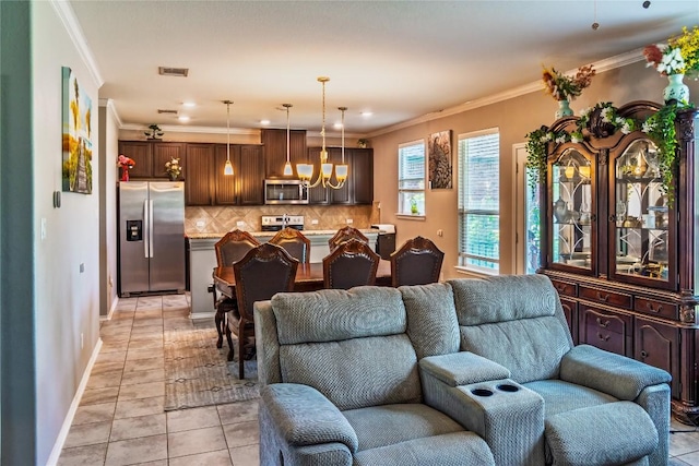2471 Sunrise Rd Unit 35, Round Rock, TX 78664 - living room featuring a chandelier, light tile patterned floors, and crown molding
