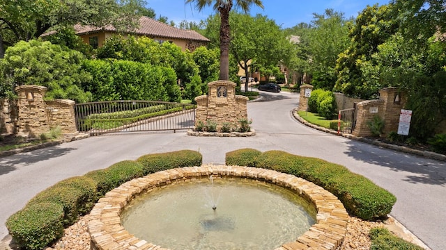 1036 Liberty Park Dr Unit 46, Austin, TX 78746 - view of home's community featuring a gate and curved driveway