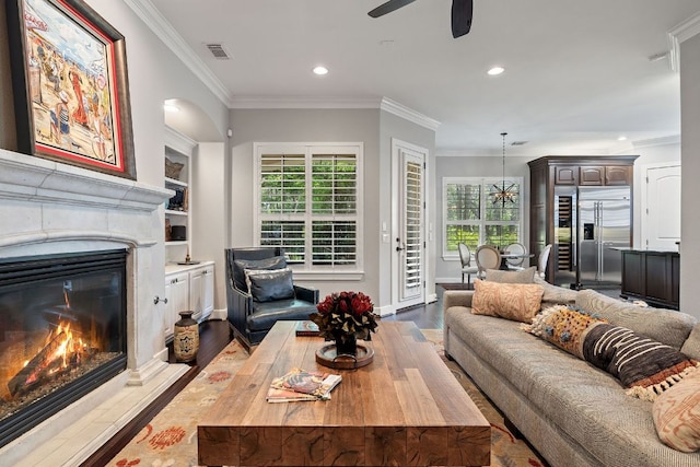 1036 Liberty Park Dr Unit 46, Austin, TX 78746 - living area with a glass covered fireplace, recessed lighting, a ceiling fan, dark wood-style floors, and ornamental molding