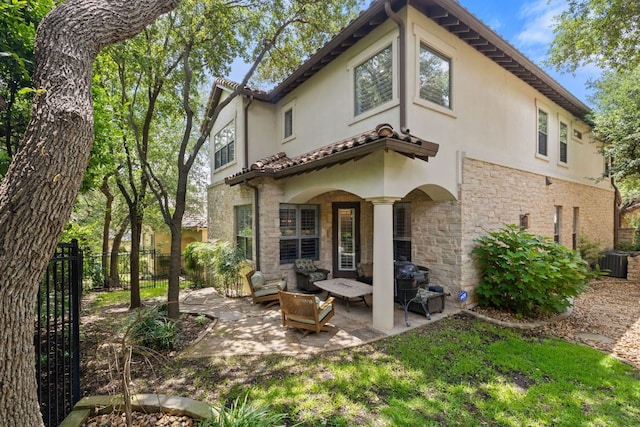 1036 Liberty Park Dr Unit 46, Austin, TX 78746 - back of property featuring stone siding, stucco siding, and a patio