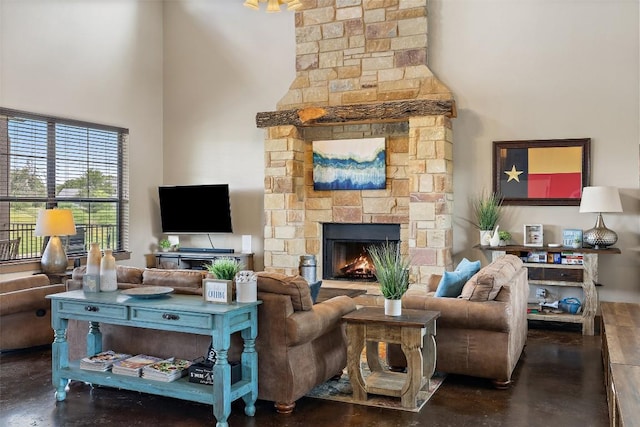 186 Sleepy Oaks Dr, Kingsland, TX 78639 - living area featuring finished concrete flooring, a fireplace, and a high ceiling