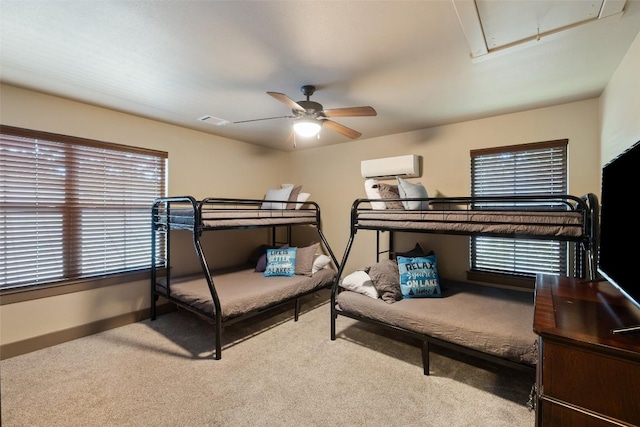 186 Sleepy Oaks Dr, Kingsland, TX 78639 - carpeted bedroom with attic access, a wall mounted AC, multiple windows, and ceiling fan