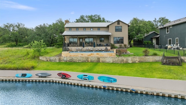 186 Sleepy Oaks Dr, Kingsland, TX 78639 - back of house featuring an outdoor pool, a chimney, a metal roof, and a patio area