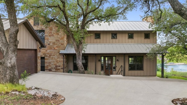 186 Sleepy Oaks Dr, Kingsland, TX 78639 - view of front of property with a standing seam roof, board and batten siding, a chimney, and concrete driveway