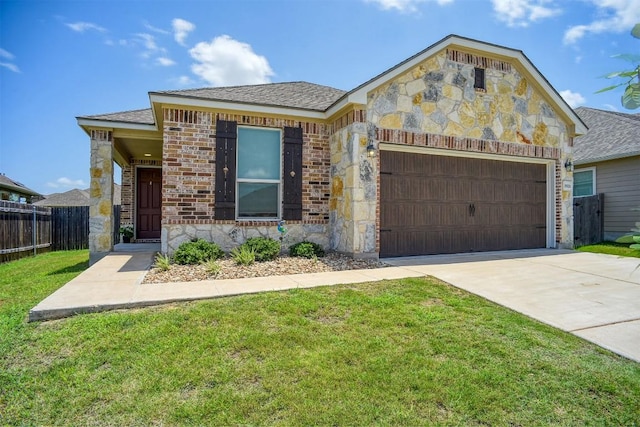 1928 Dragonfly Loop, Bastrop, TX 78602 - view of front of home with a garage, stone siding, driveway, and roof with shingles