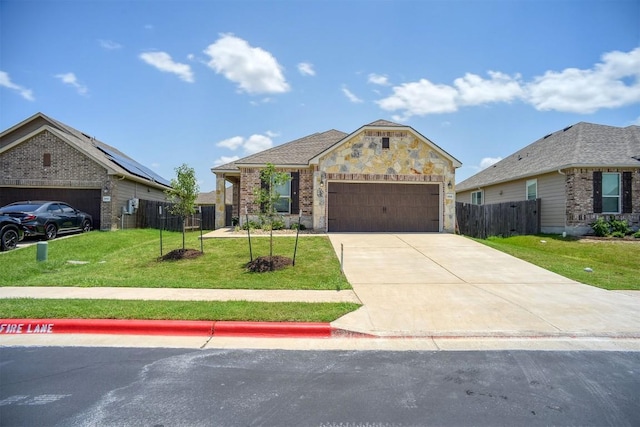 1928 Dragonfly Loop, Bastrop, TX 78602 - view of front facade featuring a garage, concrete driveway, and brick siding