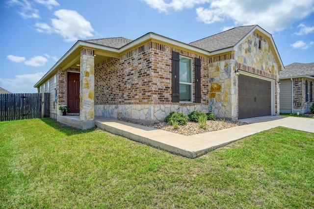 1928 Dragonfly Loop, Bastrop, TX 78602 - view of front facade featuring driveway, stone siding, an attached garage, and roof with shingles
