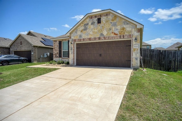 1928 Dragonfly Loop, Bastrop, TX 78602 - view of front of property featuring stone siding, an attached garage, concrete driveway, and brick siding