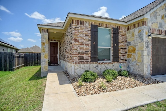 1928 Dragonfly Loop, Bastrop, TX 78602 - entrance to property with stone siding, brick siding, and an attached garage