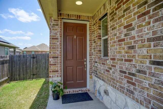 1928 Dragonfly Loop, Bastrop, TX 78602 - view of exterior entry featuring brick siding