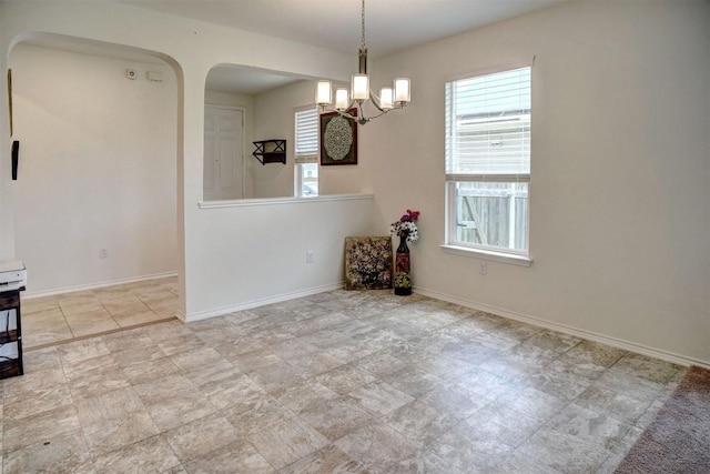 1928 Dragonfly Loop, Bastrop, TX 78602 - spare room featuring healthy amount of natural light, arched walkways, and a chandelier