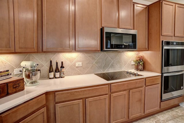 1928 Dragonfly Loop, Bastrop, TX 78602 - kitchen featuring stainless steel appliances, light countertops, and tasteful backsplash