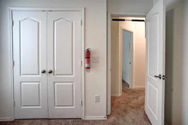 1928 Dragonfly Loop, Bastrop, TX 78602 - hallway featuring carpet floors and baseboards