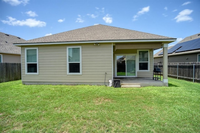 1928 Dragonfly Loop, Bastrop, TX 78602 - back of house featuring a patio, a fenced backyard, and roof with shingles