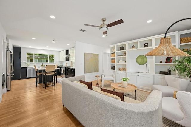 1010 Karen Ave, Austin, TX 78757 - living room with light wood-style floors, a ceiling fan, and recessed lighting