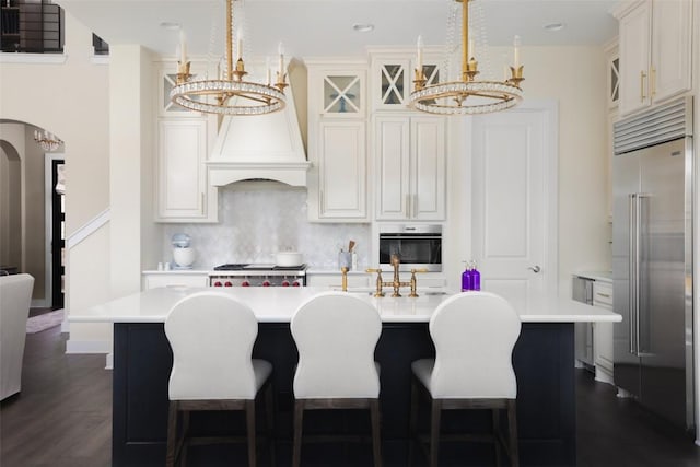 303 Marina View Ct Unit 23A, Austin, TX 78734 - kitchen featuring a chandelier, stainless steel built in fridge, light countertops, arched walkways, and recessed lighting